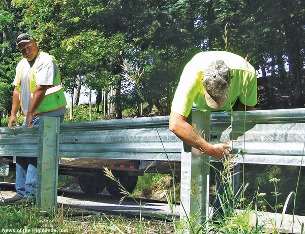 Photo by Jason Kaplan Bill Goldsmith, of the Town of Cornwall Highway Department, installs new guardrails on Hasbrouck Avenue with Kenny Davis, a foreman with Chemung Supply Company.
