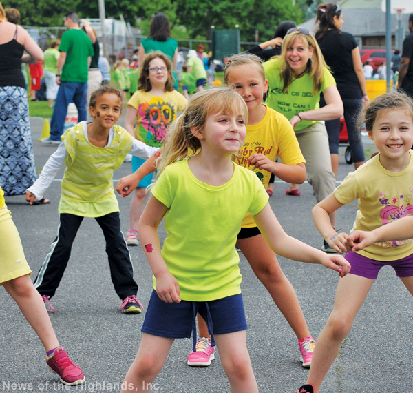 Photo by Lauree Mackay First-graders got a taste of Zumba at the Willow Avenue School Field Day on June 5. The kids lucked out with the weather. It had rained from morning till night on the previous day. Faculty member Eleonora Panzanaro is in the back.