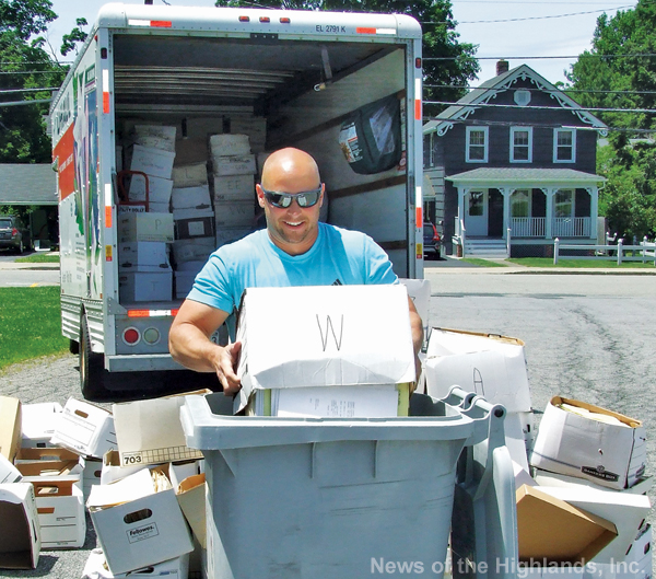 Photo by Jason Kaplan Mark Papo, of HV Shred, Inc. loads paper into a garbage bin. The Town of Cornwall and the Chamber of Commerce co-sponsored a community shredding day on June 21. See story page __. 