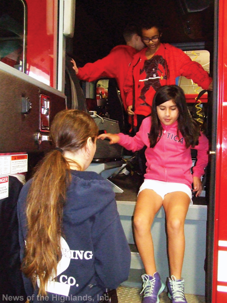 Elena Centeno climbs down from the cab of a fire truck after a class at the Storm King Engine Company