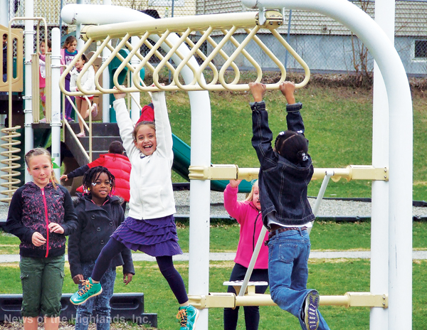 Photo by Jason Kaplan Brianna Lont, Muselee Pierre, Kristin Rosario, Zoey Travis, and Kaydence Sweat were among the Willow Avenue Elementary School students eager to take a turn on the jungle gym Monday afternoon. The students were relegated to the blacktop, during recess, for the winter. It was the first time they were allowed on the playground since last year.