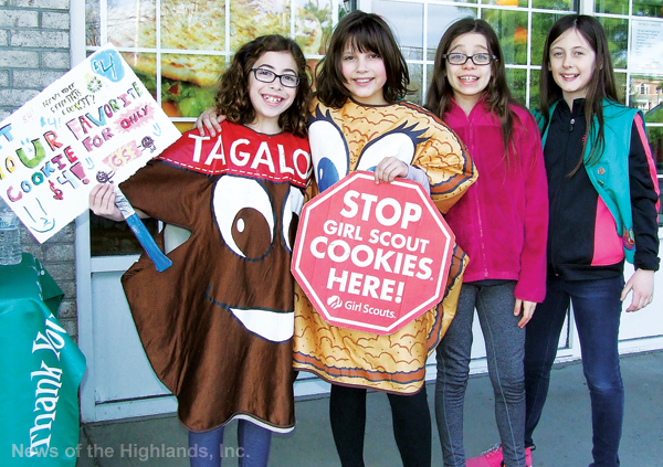 Photo by Jason Kaplan Ariel Yarmus, Juliet Zeszutek, Teresa Modugno, and Wrigley Hunt, Girl Scouts with Troop 91, took advantage of a day off from school to sell cookies at Cornwall Plaza. Yarmus and Zeszutek helped their peers by dressing like cookies and walking up and down the plaza announcing the sale. 