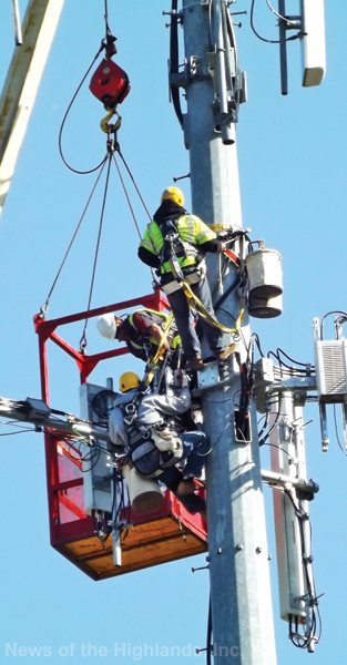 Technicians work 150’ up on the cell tower, located behind Town Hall, last week. 