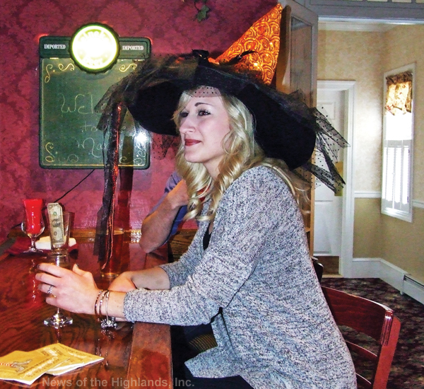Photo by Jason Kaplan Diana Karklin enjoys a drink at the bar during the second annual Witch Hat Party, held Oct. 25, at Mountainville Manor. Each guest was required to wear a witch’s hat of their own creation. The event raised $1,300 for Hospice of Orange and Sullivan Counties.