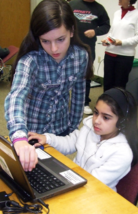 Photo by Ken Cashman Eighth-grader Judy Bennett helps third-grader Isabela Centeno during the Hour of Code at the Cornwall Public Library on Dec. 7.