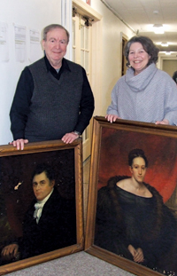 Photo by Ken Cashman Paul Gould and Maryanne O’Dell with the portraits of David Sands and Catherine Sands Ring, which Mr. Gould will restore.