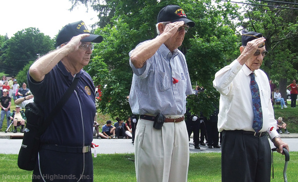 Three veterans salute after laying a wreath at the Soldier’s and Sailor’s Monument on Memorial Day. Tom Quinlan (left) served during the Vietnam era. Ray Mellin was in the Korean War, and Al Mazzocca served in World War II.