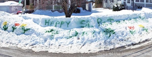 Photo by Jason Kaplan Faced with over a foot of snow, Gloria Dougan Flanagan decided to make the best of a bad situation. She spray painted a St. Patrick’s Day greeting for neighbors and passersby to see.
