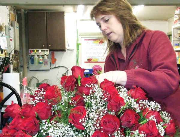 Photo by Jason Kaplan Betsy Sharo, owner of Merritt Florist, puts the finishing touches on one of three centerpieces for the West Point graduation dinner. For over 20 years she has been preparing red roses for the pre-commencement ceremony celebration. This year she and her staff prepped 2,300 roses.