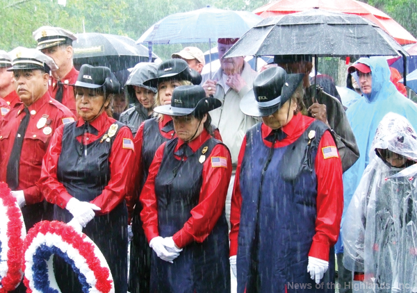 It was too wet to use a microphone, so guests moved up front, and mingled with volunteers in uniform, so they could hear.