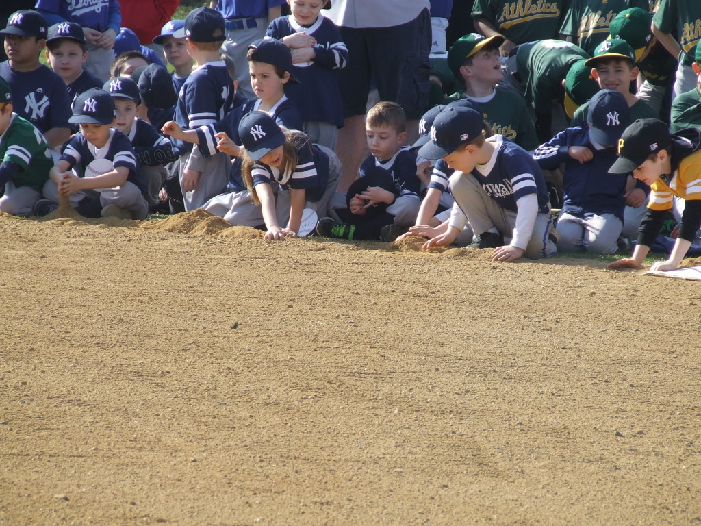 The ballplayers were attentive, but the younger ones couldn't resist playing in the dirt. 