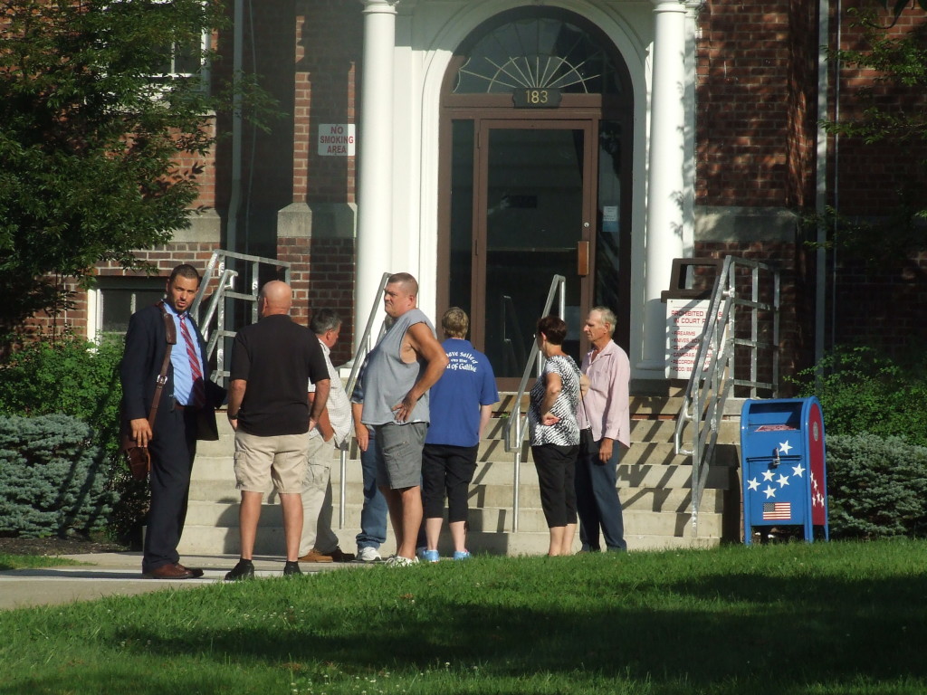 Marty Sauer (far right) and his attorney (far left) remained in front of Town Hall with supporters for several minutes after their Aug. 30 court appearance.