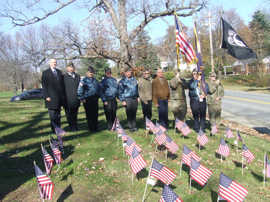 After the ceremony, veterans gathered at the American Flag display at the middle school.