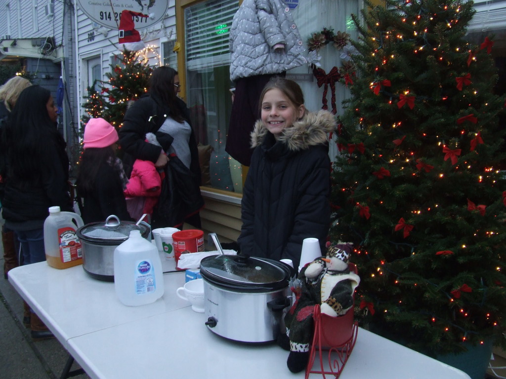 Camryn Ardovino served refreshments in front of the Hair Boutique on Main Street.
