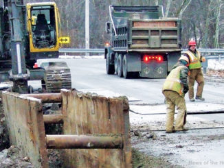 Contractors install a new water main along Jackson Avenue